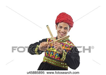 Male dandiya dancer dancing with sticks View Large Photo Image Stock Photography - Male dandiya dancer dancing with sticks . Fotosearch
