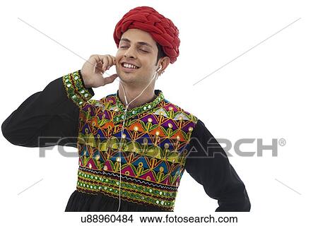 Picture - Male dandiya dancer listening to music . Fotosearch