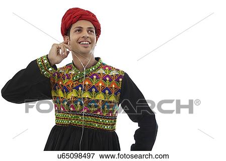 Male dandiya dancer listening to music View Large Photo Image Stock Photo - Male dandiya dancer listening to music . Fotosearch
