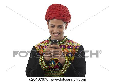 Male dandiya dancer reading an sms View Large Photo Image Stock Image - Male dandiya dancer reading an sms . Fotosearch