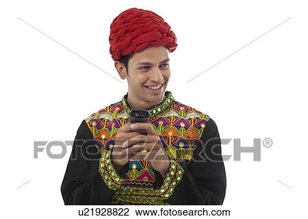 Male dandiya dancer with a mobile phone View Large Photo Image Stock Image - Male dandiya dancer with a mobile phone . Fotosearch