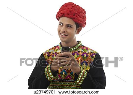 Male dandiya dancer with a mobile phone View Large Photo Image Stock Image - Male dandiya dancer with a mobile phone . Fotosearch