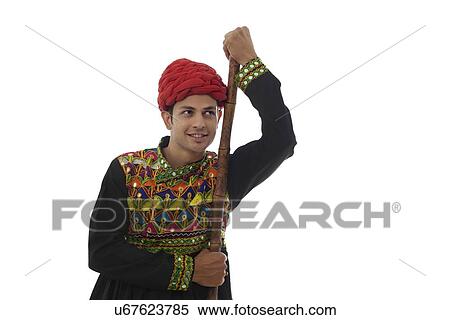 Male dandiya dancer with a stick View Large Photo Image Stock Photography - Male dandiya dancer with a stick . Fotosearch