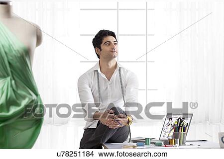 Picture - Male designer model in studio looking away . Fotosearch