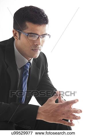 Stock Photo - Male executive with hands clasped over white background . Fotosearch