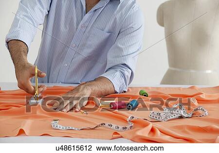 Stock Image - Male fashion designer at work . Fotosearch