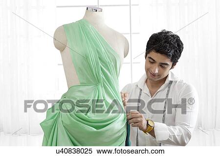 Male tailor working on dressmaker's form View Large Photo Image Stock Photography - Male tailor working on dressmaker's form . Fotosearch