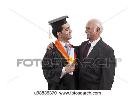 Stock Image - Man at grandson's graduation ceremony. Fotosearch