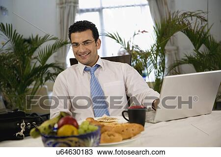 Stock Image - Man at the dining table . Fotosearch