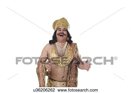Stock Image - Man dressed as Raavan laughing . Fotosearch