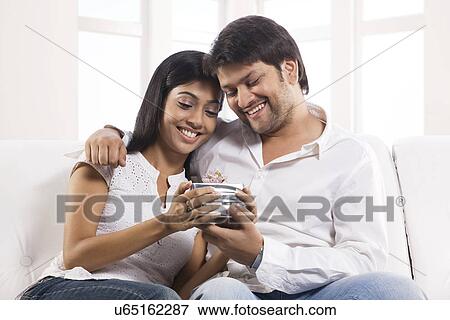 Man giving a gift to his wife View Large Photo Image Stock Photo - Man giving a gift to his wife . Fotosearch