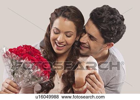 Man giving woman a bouquet of flowers View Large Photo Image Stock Photo - Man giving woman a bouquet of flowers. Fotosearch