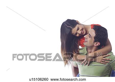 Man giving woman a piggyback ride View Large Photo Image Stock Image - Man giving woman a piggyback ride. Fotosearch