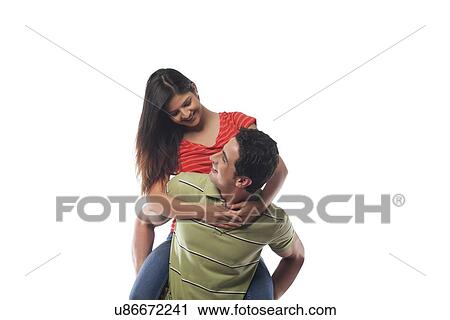 Man giving woman a piggyback ride View Large Photo Image Stock Image - Man giving woman a piggyback ride. Fotosearch