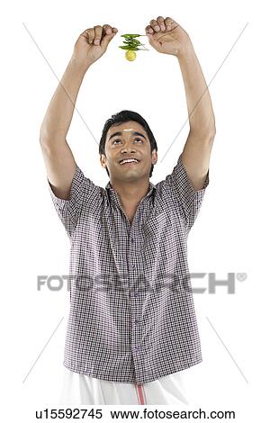 Man hanging lemon and chilli View Large Photo Image Stock Photography - Man hanging lemon and chilli . Fotosearch