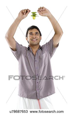 Man holding lemon and chillies View Large Photo Image Stock Image - Man holding lemon and chillies . Fotosearch