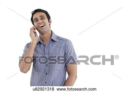 Man laughing while having conversation on phone View Large Photo Image Stock Photo - Man laughing while having conversation on phone . Fotosearch