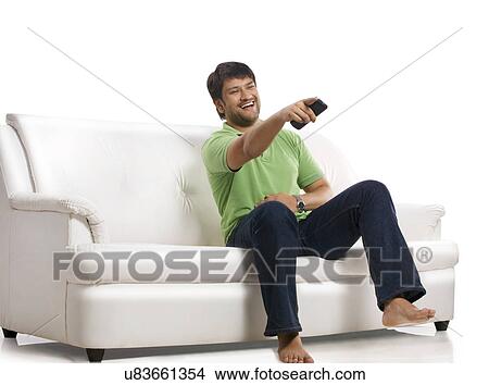 Man laughing while watching television View Large Photo Image Picture - Man laughing while watching television . Fotosearch
