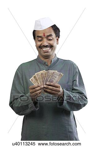 Stock Photography - Man looking at Indian currency . Fotosearch