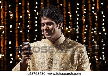 Man reading an sms on mobile phone View Large Photo Image Stock Image - Man reading an sms on mobile phone. Fotosearch