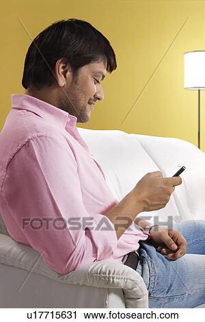 Man reading an sms View Large Photo Image Stock Image - Man reading an sms . Fotosearch
