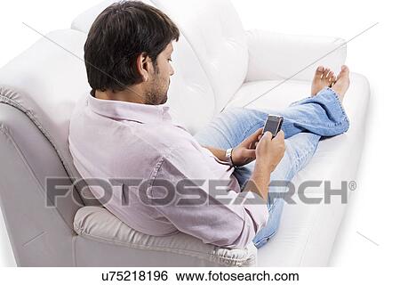 Man sending an sms View Large Photo Image Stock Photograph - Man sending an sms . Fotosearch
