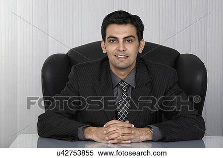 Man sitting in the office View Large Photo Image Stock Photography - Man sitting in the office . Fotosearch