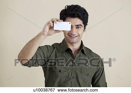 man take a snap shot over colored background View Large Photo Image Stock Photo - man take a snap shot over colored background . Fotosearch