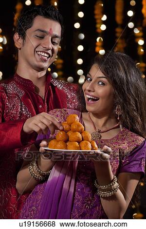 Man taking sweets from plate View Large Photo Image Stock Photo - Man taking sweets from plate. Fotosearch
