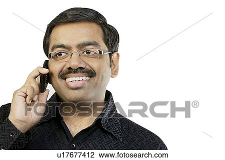 Man talking on a mobile phone View Large Photo Image Stock Image - Man talking on a mobile phone . Fotosearch