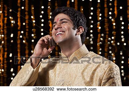 Stock Image - Man talking on a mobile phone. Fotosearch