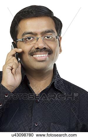 Stock Image - Man talking on a mobile phone . Fotosearch