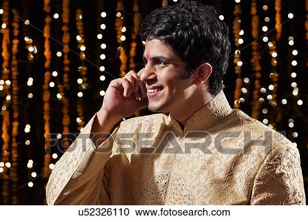 Stock Image - Man talking on a mobile phone. Fotosearch