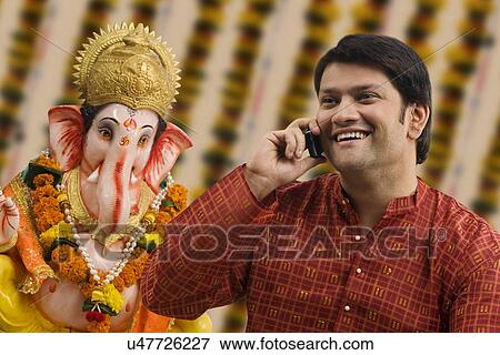 Stock Photo - Man talking on a mobile phone . Fotosearch