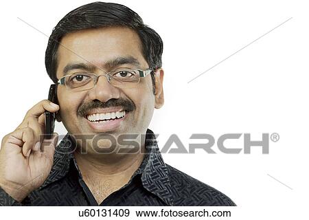 Stock Photo - Man talking on a mobile phone . Fotosearch