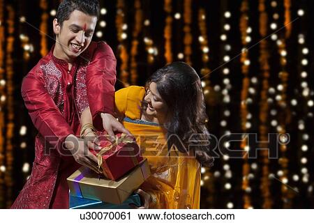 Man trying to snatch gifts from woman View Large Photo Image Stock Image - Man trying to snatch gifts from woman. Fotosearch