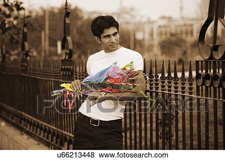 Stock Photo - Man waiting with a bouquet of flowers . Fotosearch