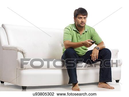 Stock Image - Man watching television . Fotosearch