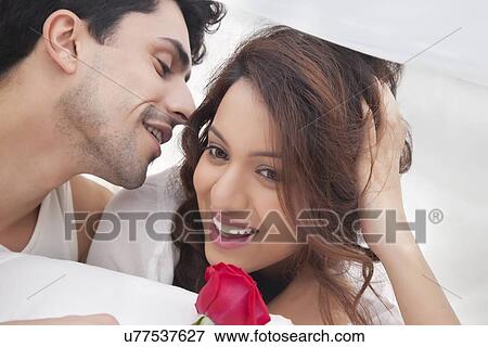 Man whispering in womans ear View Large Photo Image Stock Photo - Man whispering in womans ear. Fotosearch