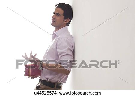 Picture - Man with a gift waiting for his date. Fotosearch