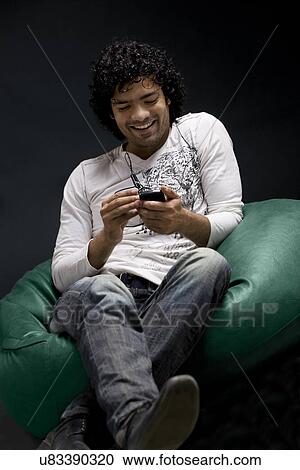 Man with his mobile phone View Large Photo Image Stock Image - Man with his mobile phone . Fotosearch