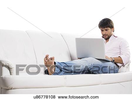 Man working on a laptop View Large Photo Image Stock Photo - Man working on a laptop . Fotosearch