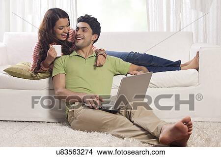Picture - Married couple with a laptop. Fotosearch