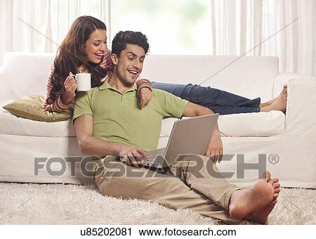 Stock Image - Married couple with a laptop. Fotosearch