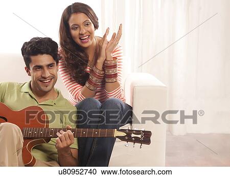 Stock Image - Married couple with guitar. Fotosearch