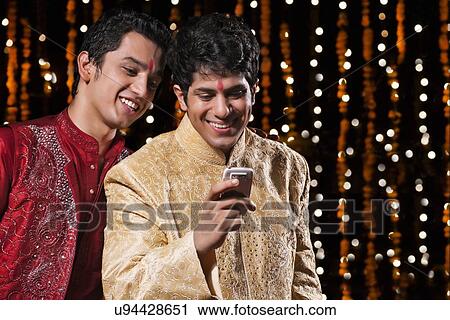Men reading sms on mobile phone View Large Photo Image Stock Image - Men reading sms on mobile phone. Fotosearch