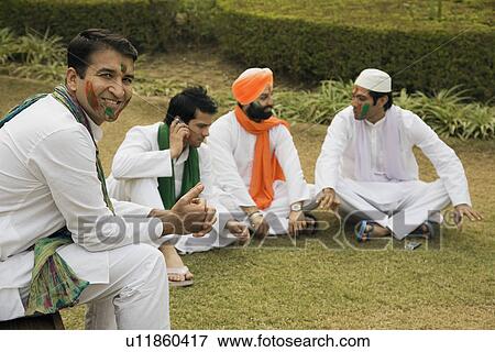 Men relaxing during Holi View Large Photo Image Stock Photo - Men relaxing during Holi . Fotosearch