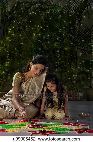 Mother and daughter arranging diyas View Large Photo Image Stock Image - Mother and daughter arranging diyas . Fotosearch