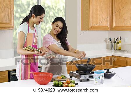 Mother and daughter cooking in the kitchen View Large Photo Image Stock Image - Mother and daughter cooking in the kitchen . Fotosearch