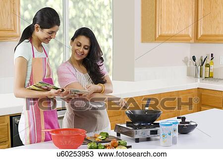 Mother and daughter cooking in the kitchen View Large Photo Image Stock Image - Mother and daughter cooking in the kitchen . Fotosearch